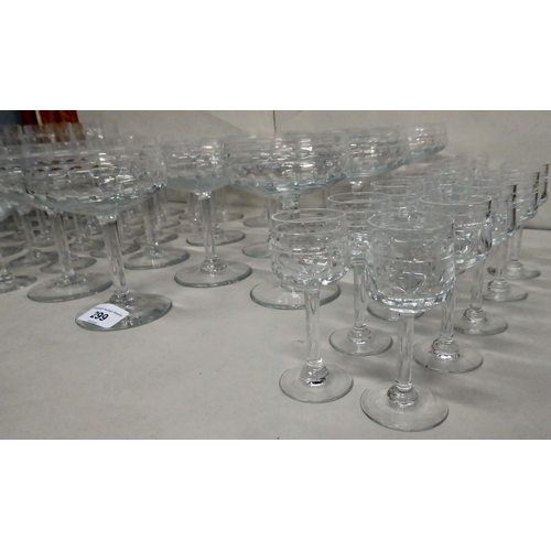 299 - A suite of Art Deco inspired crystal drinking glasses, each with line and circle cut ornament