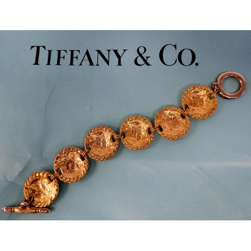 304 - A Tiffany & Co white metal wire bracelet; a Bulgari bi-coloured metal necklet, on a fine chain; ... 