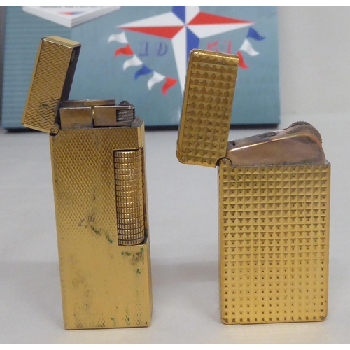 319 - Two gilt finished gas lighters, viz. a Dunhill; and a Myon