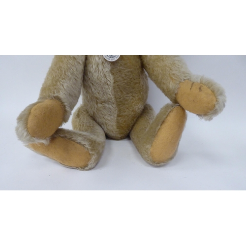 32 - A Steiff 1907 replica mohair covered Teddy bear with a mobile head, limbs and a stitched nose  ... 