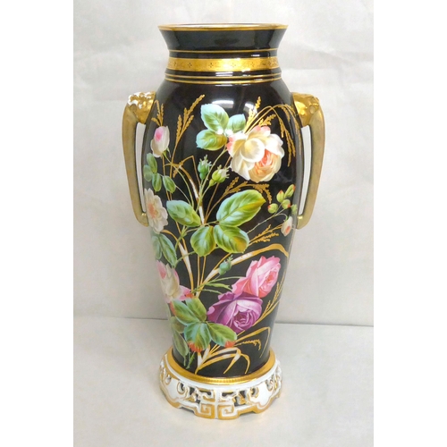 323 - A late 19thC Continental porcelain vase with opposing lion mask handles, decorated with roses  ... 