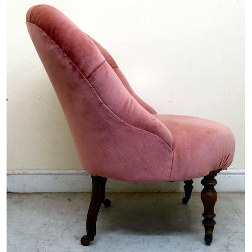 339 - A late Victorian mahogany boudoir chair, upholstered in part buttoned, dusky pink dralon, raised on ... 