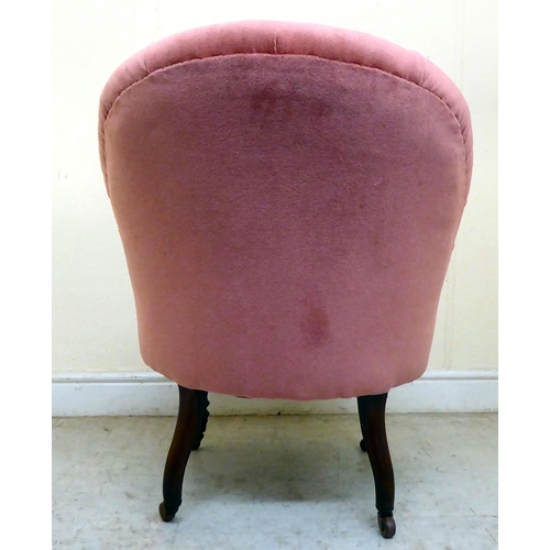 339 - A late Victorian mahogany boudoir chair, upholstered in part buttoned, dusky pink dralon, raised on ... 