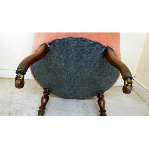 339 - A late Victorian mahogany boudoir chair, upholstered in part buttoned, dusky pink dralon, raised on ... 