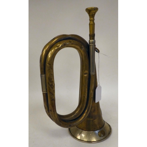 34 - A German brass bugle with an impressed eagle and swastika emblem(Please Note: this lot is subject to... 