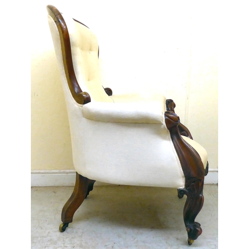 344 - A late Victorian carved mahogany showwood framed, waisted spoonback grandfather chair with enclosed ... 