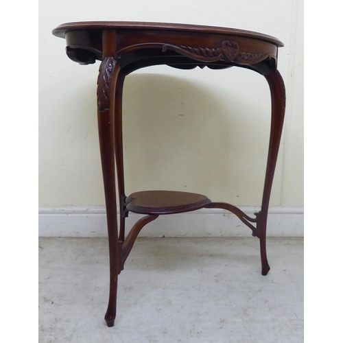 346 - An Edwardian mahogany heart shape occasional table, the top with a carved and shaped apron, raised o... 