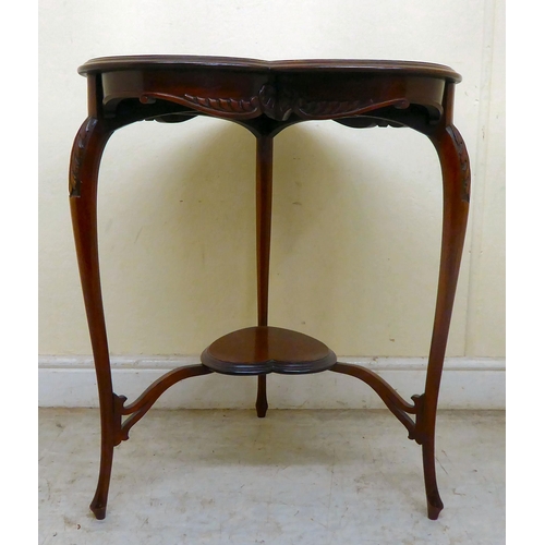 346 - An Edwardian mahogany heart shape occasional table, the top with a carved and shaped apron, raised o... 