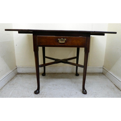 356 - A late Georgian oak Pembroke table with a frieze drawer and cast brass bail handles, raised on turne... 