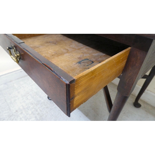 356 - A late Georgian oak Pembroke table with a frieze drawer and cast brass bail handles, raised on turne... 