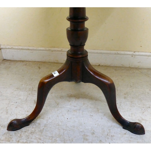 360 - An early 19thC mahogany tip-top pedestal table, over a ring turned column, raised on a cabriole trip... 