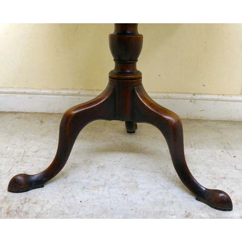 360 - An early 19thC mahogany tip-top pedestal table, over a ring turned column, raised on a cabriole trip... 