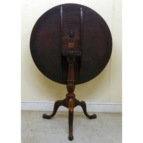 360 - An early 19thC mahogany tip-top pedestal table, over a ring turned column, raised on a cabriole trip... 