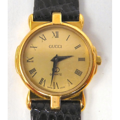 373 - A lady's Gucci yellow metal wristwatch, the quartz movement faced by a Roman dial, on a dedicated bl... 