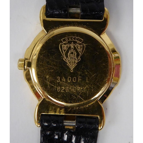 373 - A lady's Gucci yellow metal wristwatch, the quartz movement faced by a Roman dial, on a dedicated bl... 