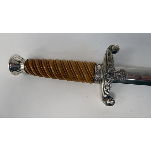 376 - A German Army officer's dagger with an orange coloured wrythen moulded grip and spreadeagle emblem, ... 