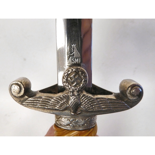 376 - A German Army officer's dagger with an orange coloured wrythen moulded grip and spreadeagle emblem, ... 