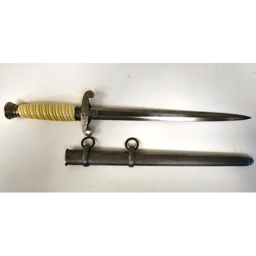 377 - A German Army officer's dagger with a cream coloured wrythen moulded grip and spreadeagle emblem on ... 