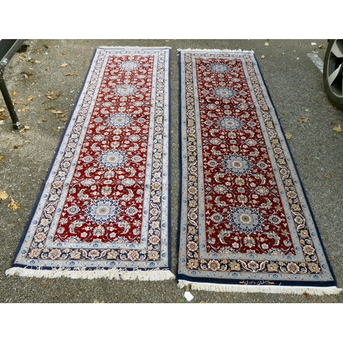 383 - A pair of Isfahan runners, each with a central pole medallion, on a red and blue ground  bears ... 