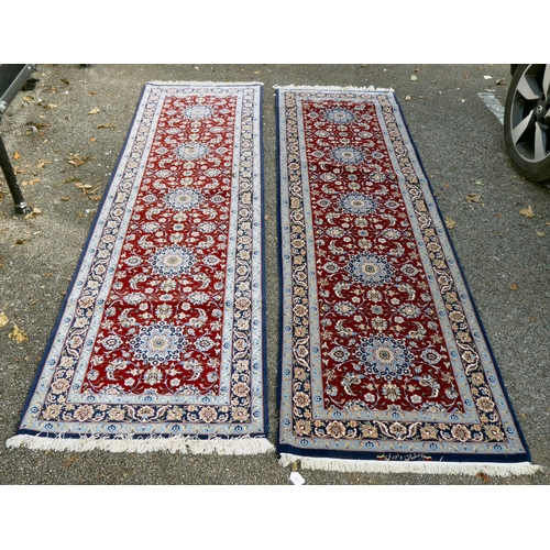 383 - A pair of Isfahan runners, each with a central pole medallion, on a red and blue ground  bears ... 