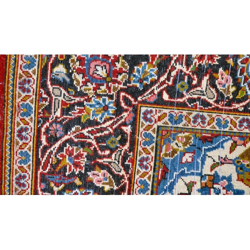 384 - A Kashan rug with floral motifs, on a red ground  83