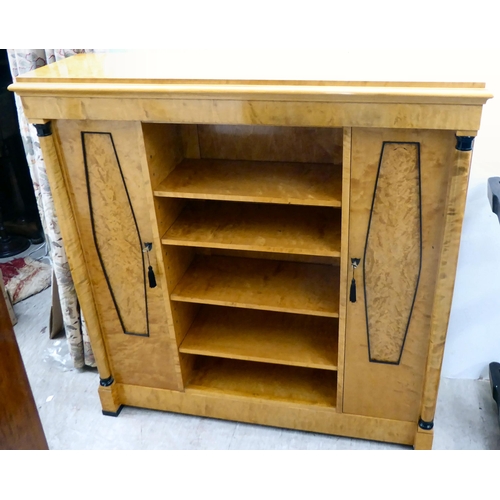 387 - A modern Egyptian Biedermeier style bleached and maple veneered breakfront bookcase with a shelved t... 