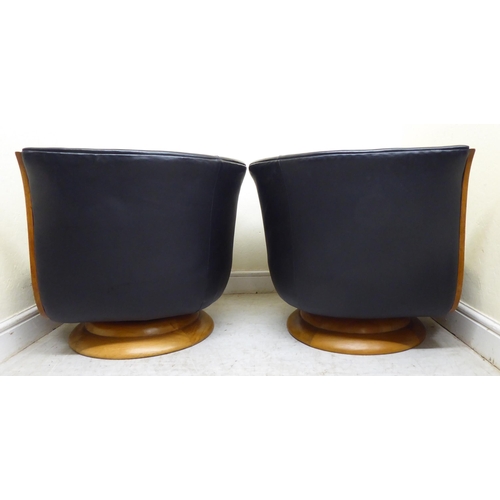 393 - A pair of modern Hotel le Malandre Model Depose maple veneered, tulip armchairs with wooden facings,... 