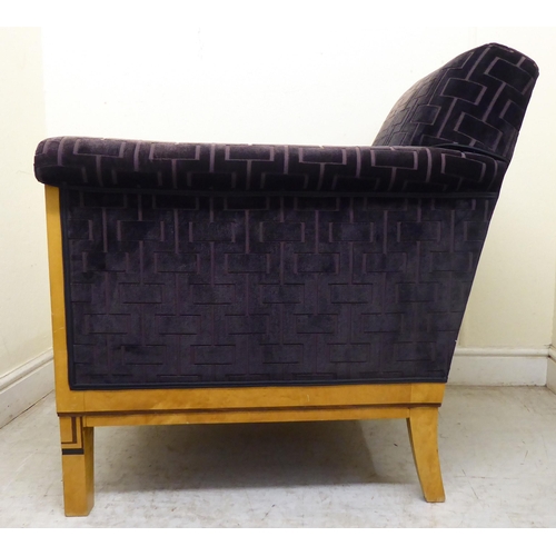 394 - A modern showwood maple veneered and inlaid Art Deco style club armchair with a low back and enclose... 