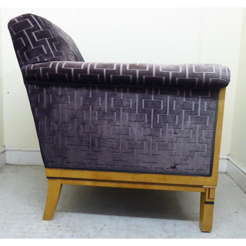 394 - A modern showwood maple veneered and inlaid Art Deco style club armchair with a low back and enclose... 