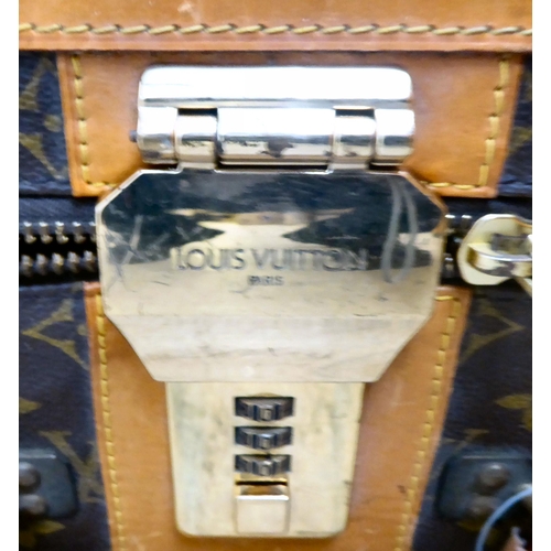 395 - A Louis Vuitton suitcase with a double zipped opening and a combination lock  11