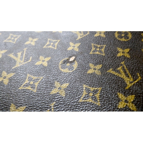 395 - A Louis Vuitton suitcase with a double zipped opening and a combination lock  11