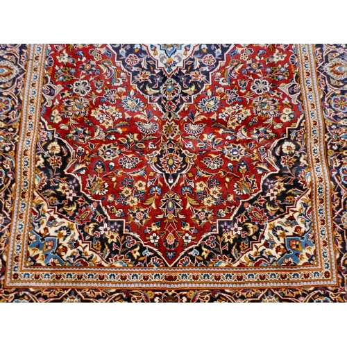 399 - An Iranian Keshan rug, decorated with repeating foliage designs, on a multi-coloured ground  80... 