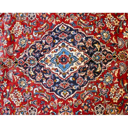 399 - An Iranian Keshan rug, decorated with repeating foliage designs, on a multi-coloured ground  80... 