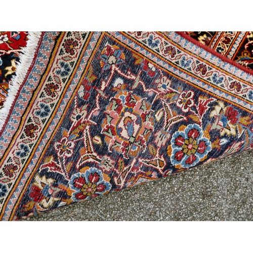 399 - An Iranian Keshan rug, decorated with repeating foliage designs, on a multi-coloured ground  80... 