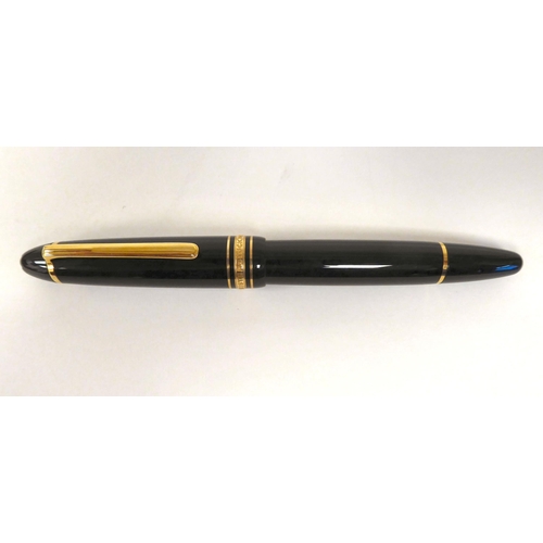 405 - A Mont Blanc fountain pen with a 14ct gold nib  stamped 810  boxed with guarantee for 1987