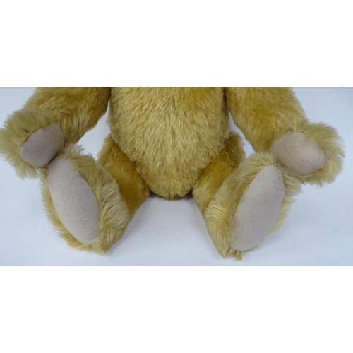 42 - A Steiff golden plush mohair covered Teddy bear with a mobile head, limbs, a stitched nose and a gro... 