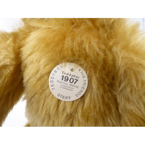 47 - A Steiff 1907 replica golden plush mohair covered Teddy bear with a mobile head, limbs, a stitched n... 