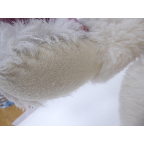 52 - A Steiff white mohair covered Teddy bear with a mobile head, limbs and a stitched nose  22