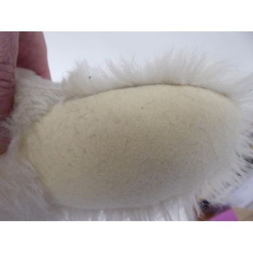 52 - A Steiff white mohair covered Teddy bear with a mobile head, limbs and a stitched nose  22