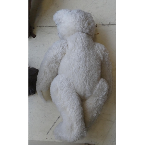 52 - A Steiff white mohair covered Teddy bear with a mobile head, limbs and a stitched nose  22