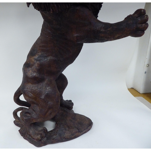 55 - A carved and stained model male lion, in a fighting pose, reared up on his hind legs  23