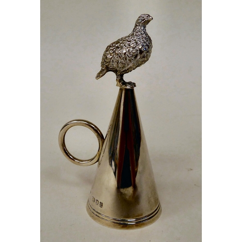 57 - A modern silver cone shape candle extinguisher with a ring handle, surmounted by grouse  Brian Lesli... 