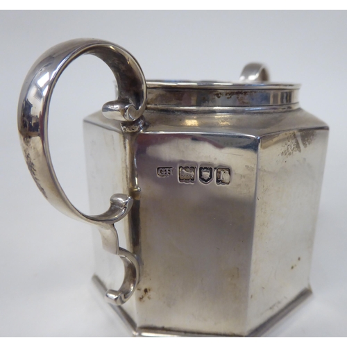 64 - A three piece silver tea set of octagonal form, comprising a hot water pot with a high spout, hinged... 