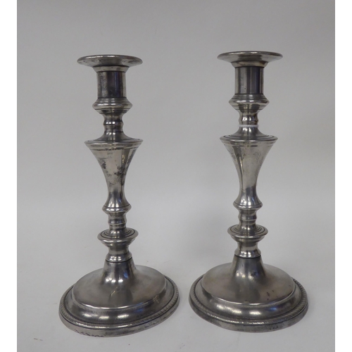 68 - Two pairs of similar 19thC pewter candlesticks, incorporating vase shape sockets, ring knopped and b... 