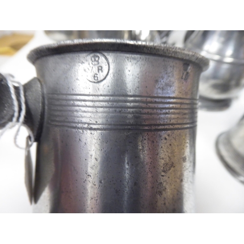 77 - Ten 17th and 18thC pewter mugs: to include quart size, pint and similar of varying designs