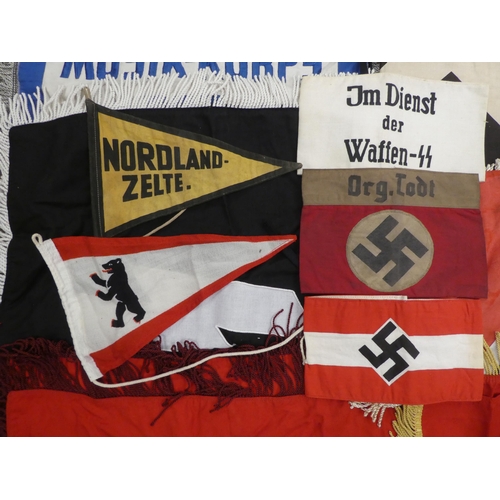 87 - A collection of Nazi era, fabric banners and flags: to include swastika and SS emblems(Please Note: ... 