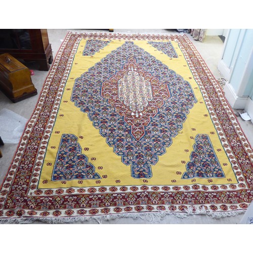 386 - A Senneh Kelim rug with a central diamond motif, on a yellow ground  76