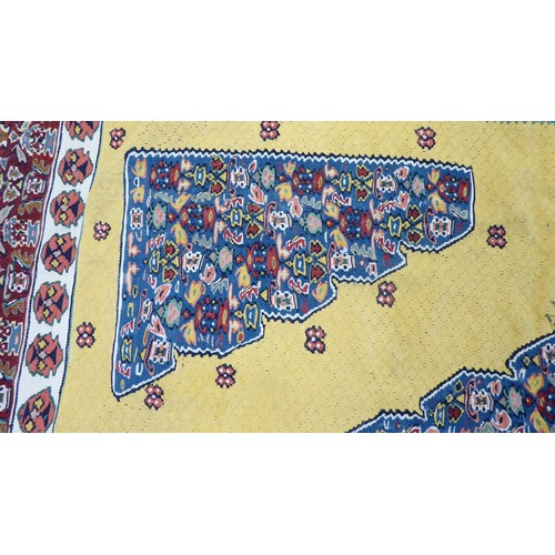 386 - A Senneh Kelim rug with a central diamond motif, on a yellow ground  76