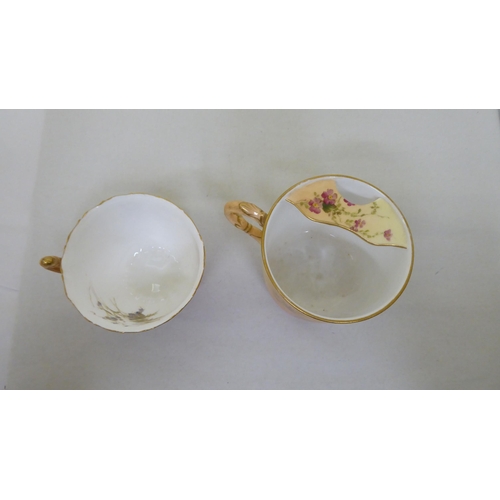 178 - A Royal Worcester china moustache cup and saucer; and another cup and saucer, date cyphers between 1... 