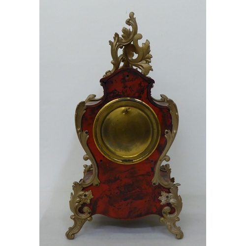 206 - A modern reproduction of an antique inspired faux boulle and tortoiseshell cased mantel clock with c... 